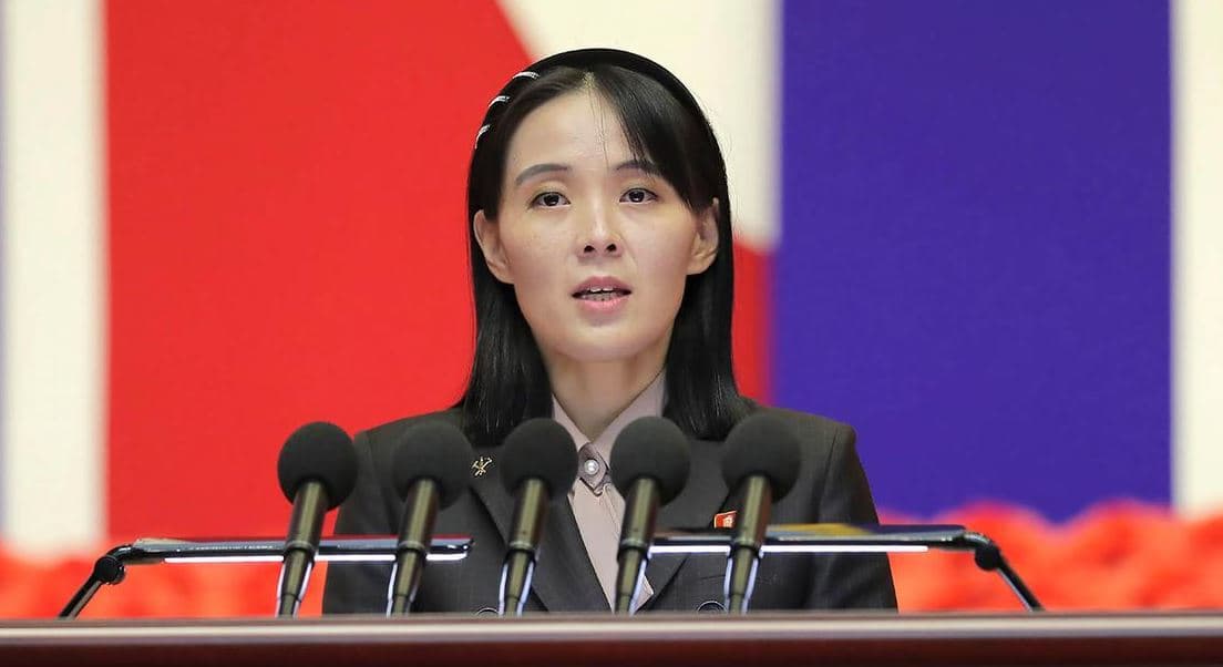 Kim Yo Jong speaking at a podium with multiple microphones during a public address on North Korea's nuclear policy and response to G7 denuclearization demands.