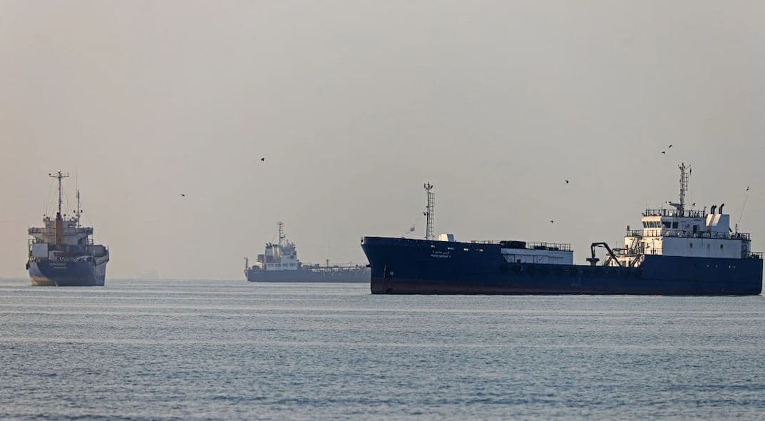 Commercial oil tankers sailing through the Strait of Hormuz during heightened US-Iran tensions and maritime security concerns.