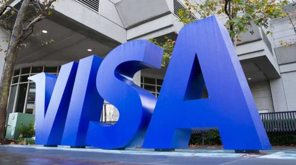 Large Visa logo outside the company's headquarters following the announcement of 2,600 layoffs despite strong quarterly earnings in 2026.